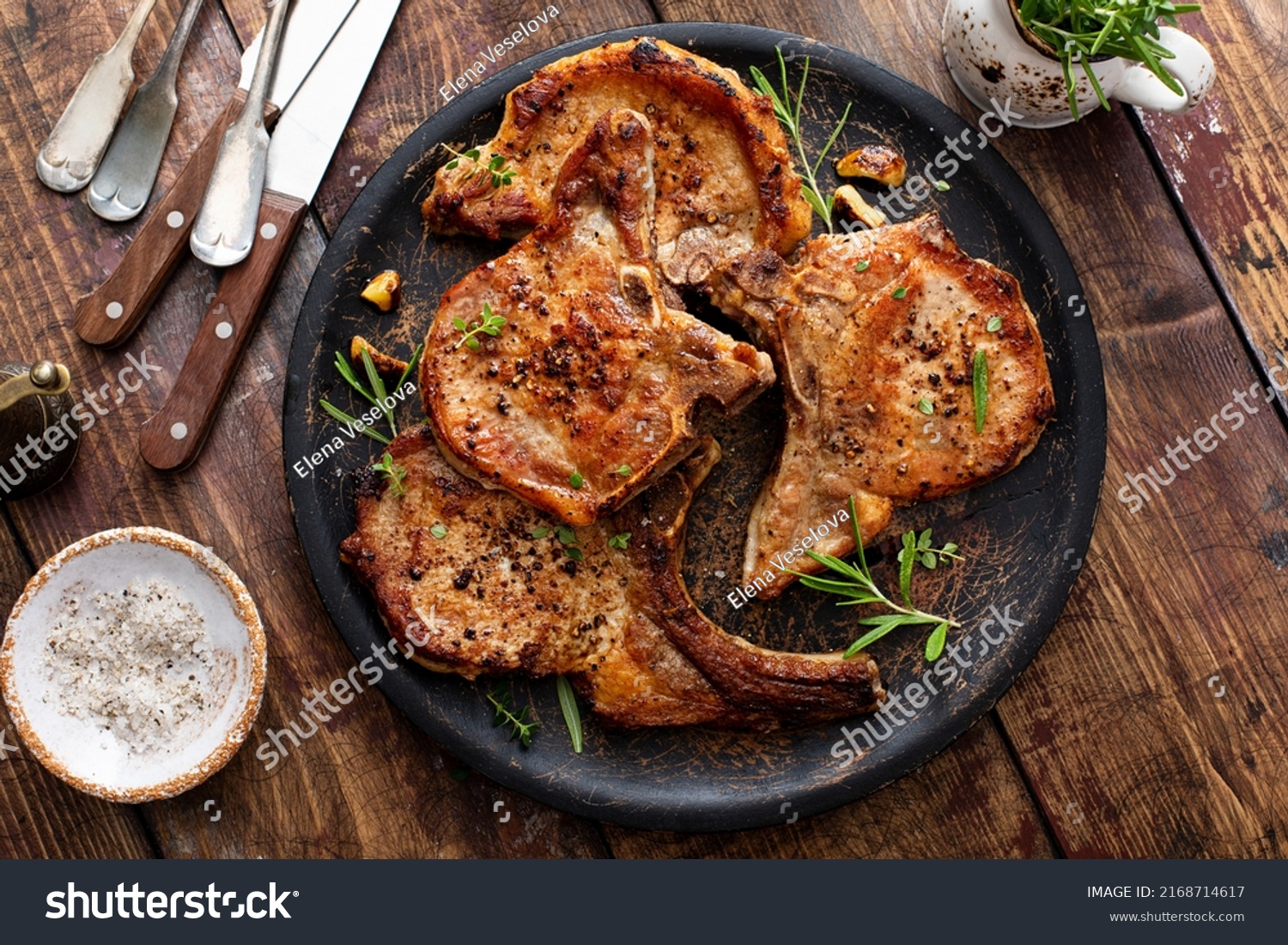 Grilled or pan fried pork chops on the bone with garlic and rosemary #2168714617