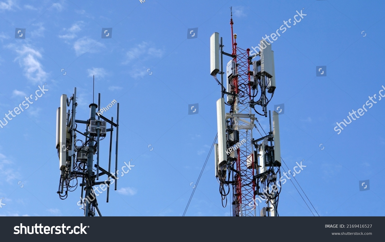 Telecommunication tower of 4G and 5G cellular. Macro Base Station. 5G radio network telecommunication equipment with radio modules and smart antennas mounted on a metal against cloulds sky background. #2169416527