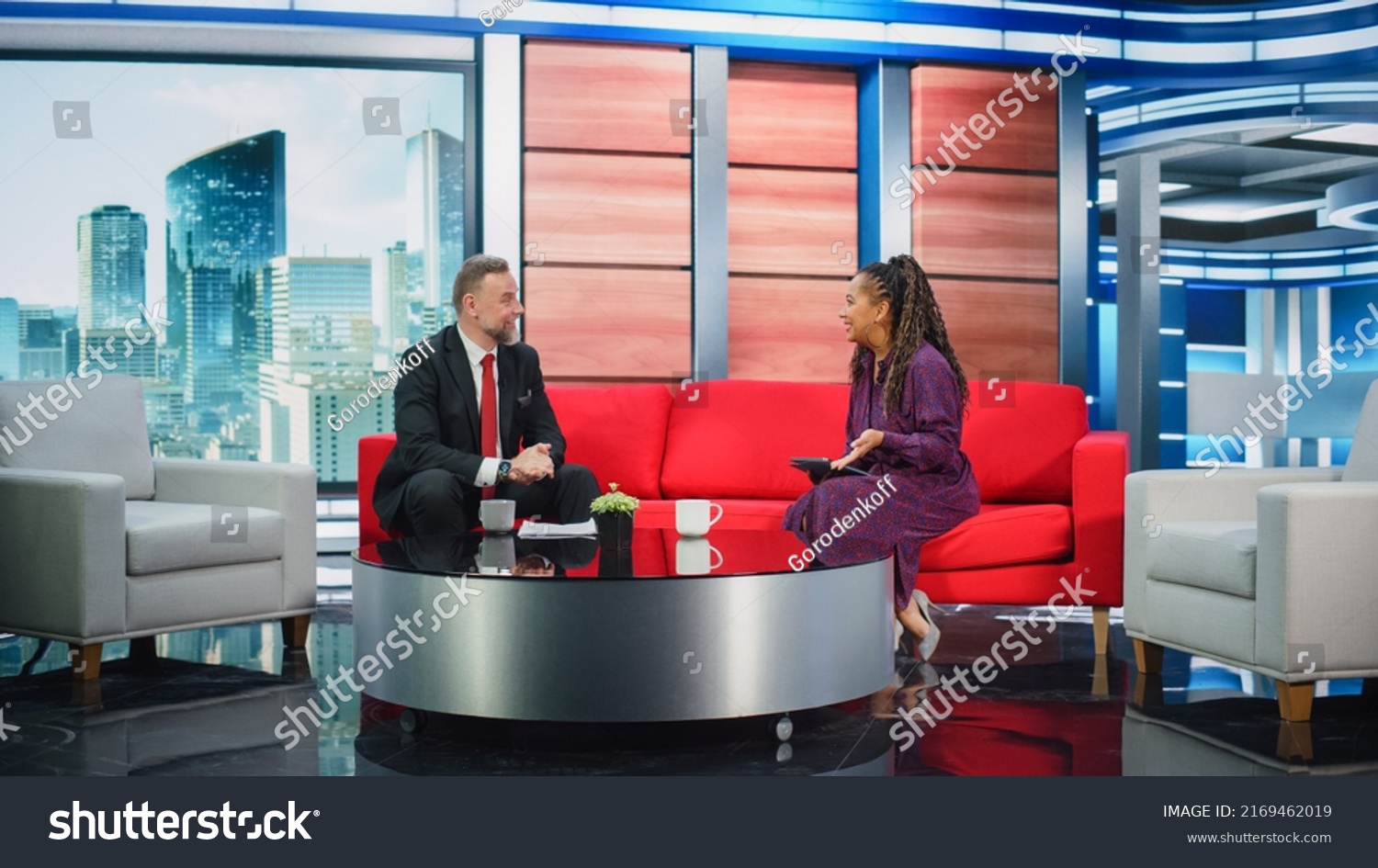 Talk Show TV Program Ending, News Interview, Discussion: Presenter and Guest Talk. Cable Channel Hosts Saying Goodbye to the Audience. Mock-up Television Studio, Newsroom Entertainment Concept #2169462019