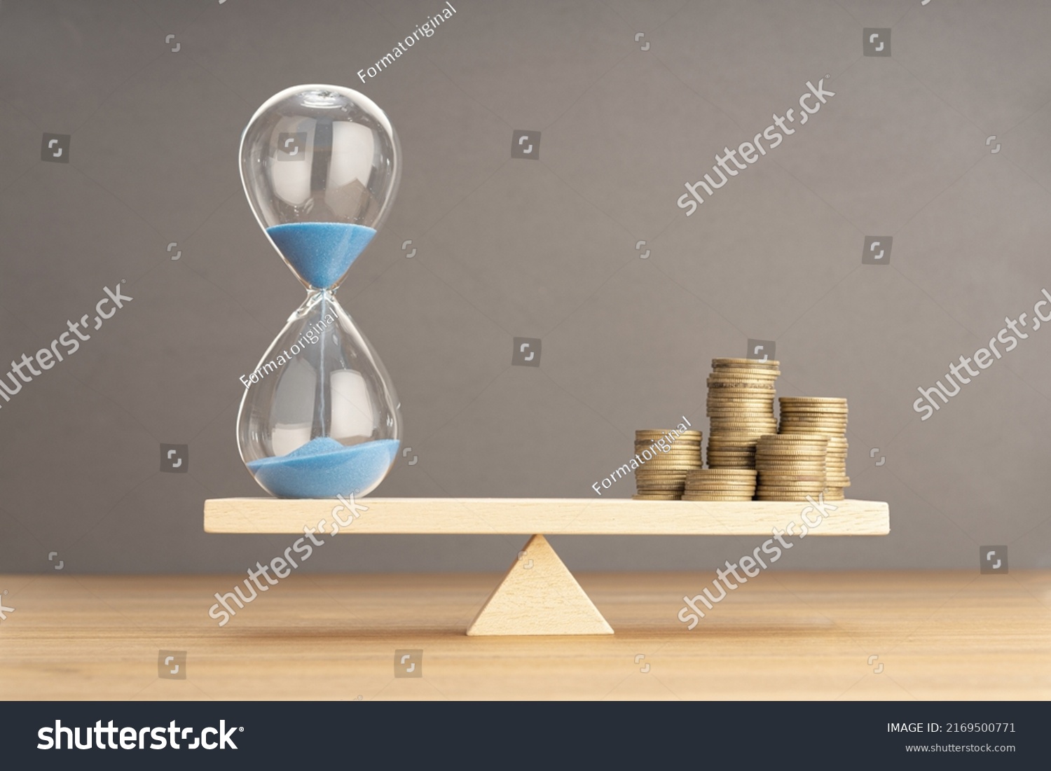 Balance Between Time and money concept. Sand clock and stacked coins on Seesaw. Copy space #2169500771