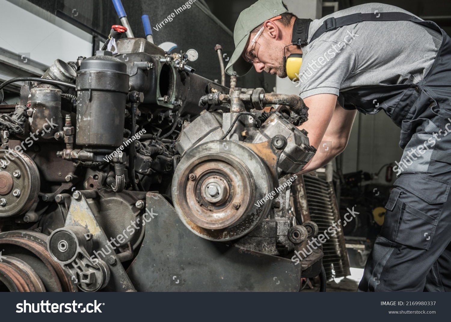 Rebuilding Heavy Duty Coach Bus Diesel Engine. Professional Caucasian Mechanic Taking Closer Look. Automotive Industry. #2169980337