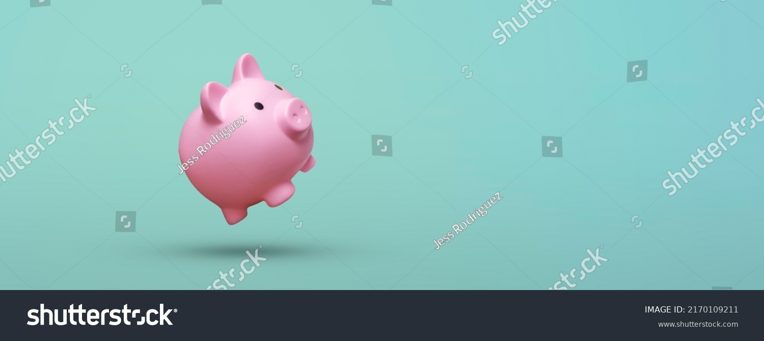 Pink piggy bank floating on blue background #2170109211