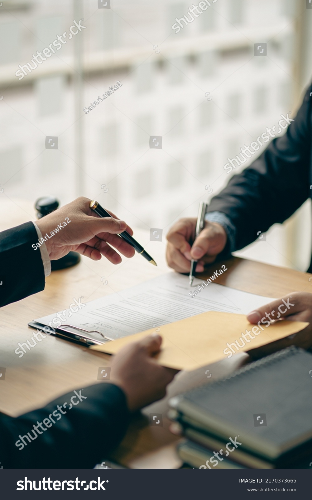 Business people or lawyers discussing contracts or business deals at a law firm. Justice advice service concept with hammer and goddess of justice beside, vertical image. #2170373665