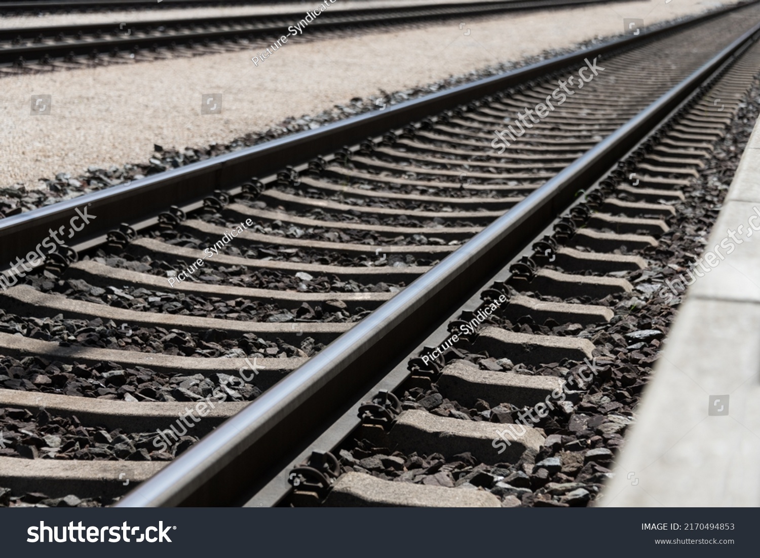 Photo of railroad tracks running diagonally through the picture with partially visible platform as concept for direction travel sadness and loneliness #2170494853