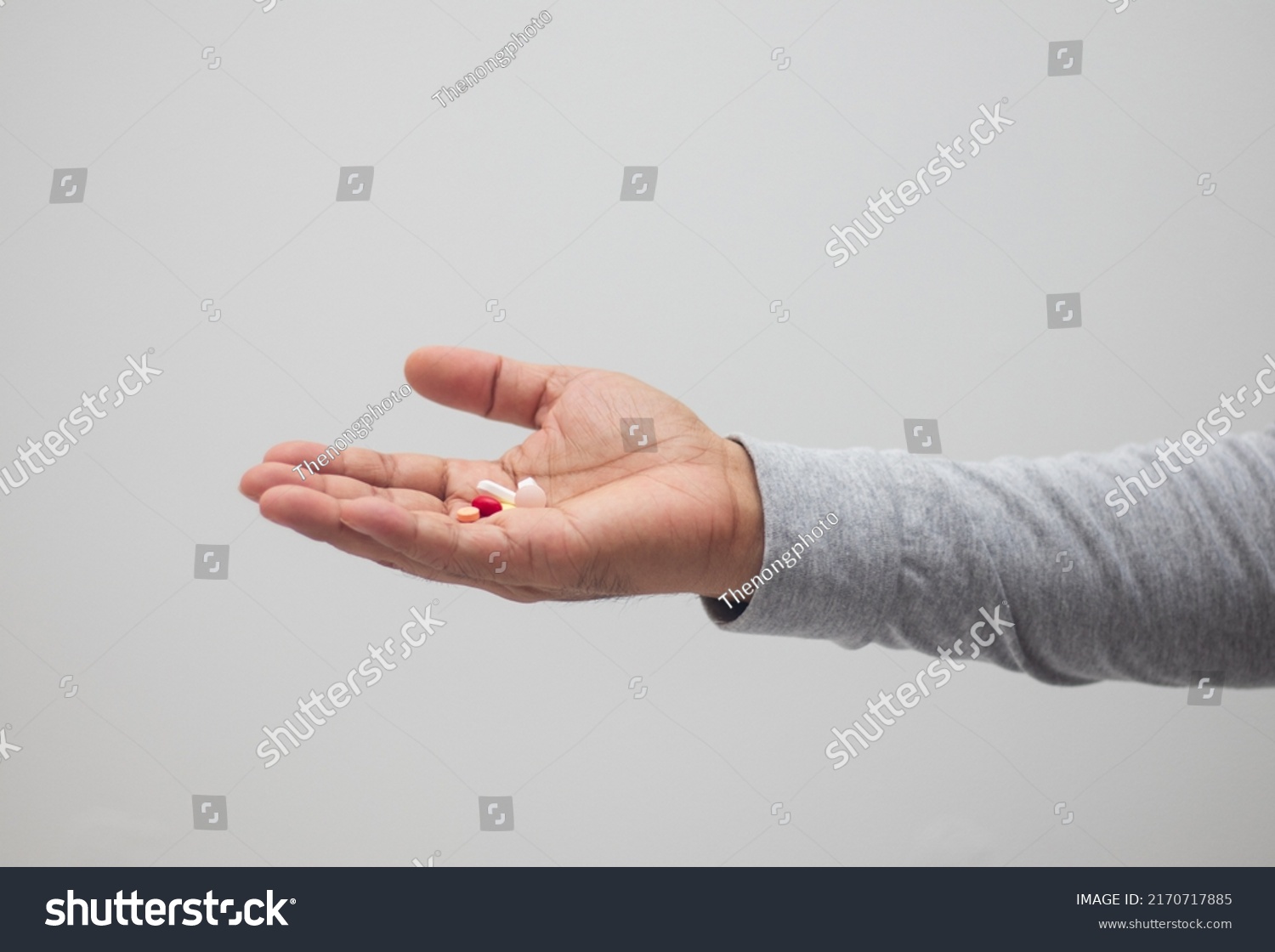 hand holding medicine capsule white background #2170717885