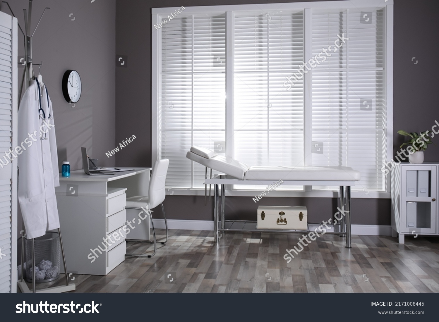 Modern medical office interior with doctor's workplace and examination table #2171008445