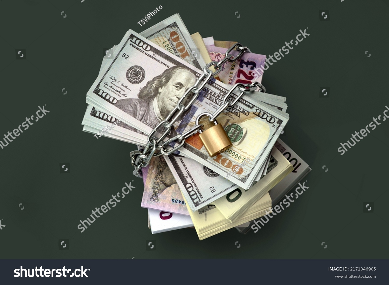 Dollars and banknotes of different countries are locked and chained in the background. Monetary crisis, financial problems, sanctions, default. The concept is the up-to-date relevant situation #2171046905
