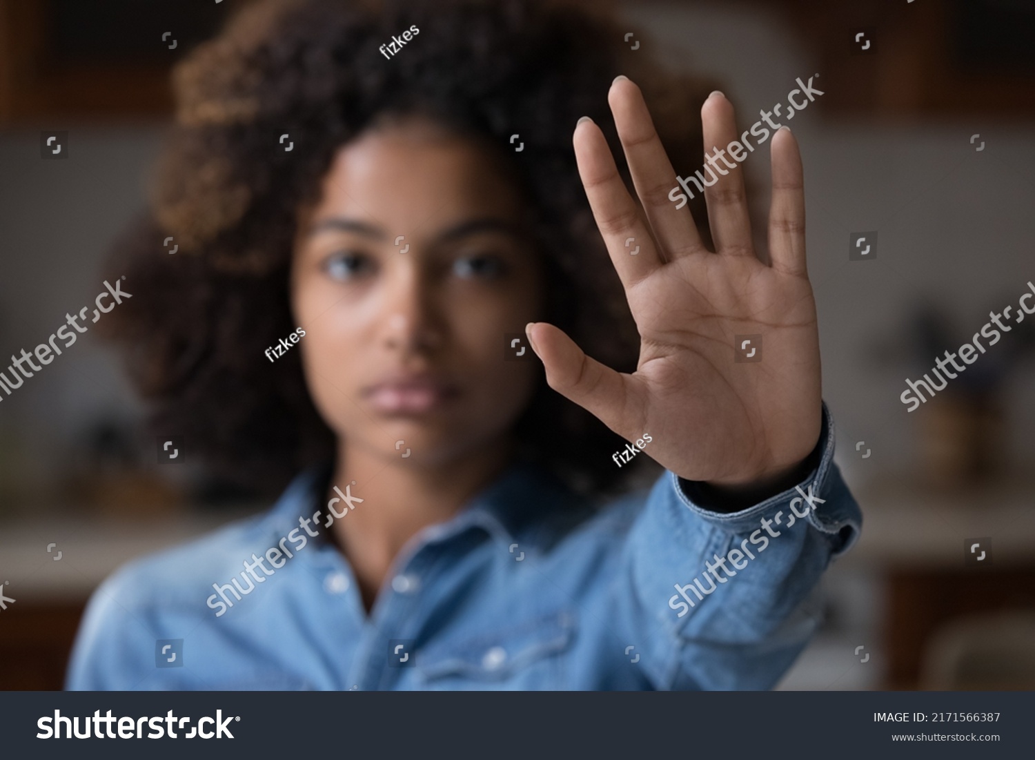 Close up focus African woman show palm hand opposes racial or gender discrimination, make stop gesture, sign of protest, female against domestic violence, abortion, bullying at school, say no concept #2171566387