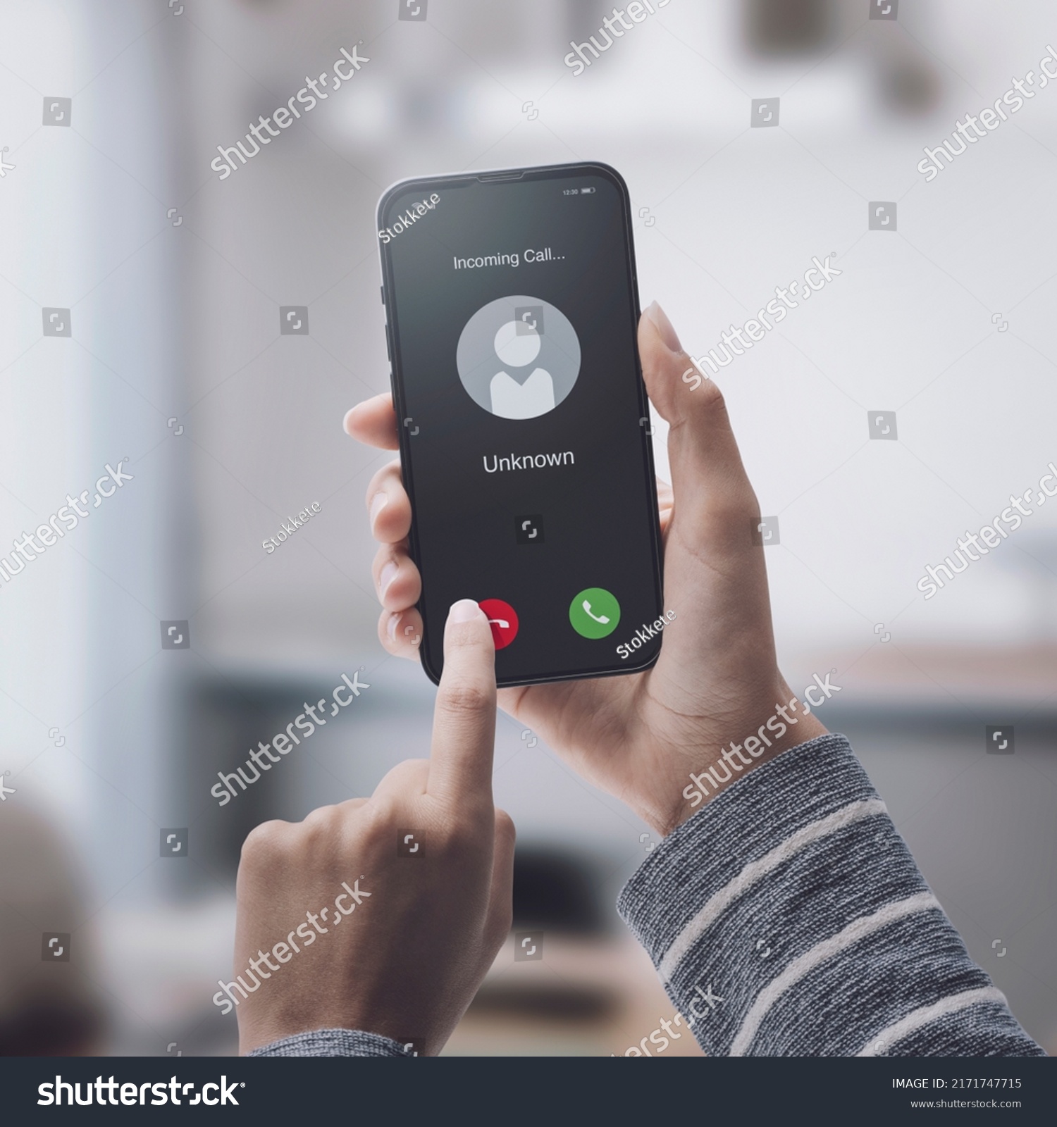 Woman receiving a call on her smartphone from an unknown number, malicious phone calls concept #2171747715