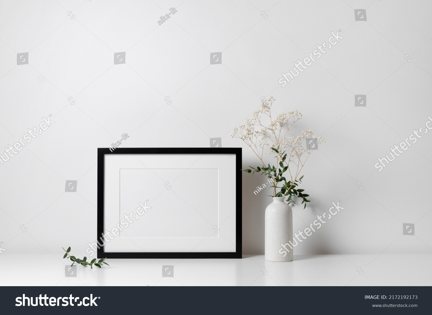 Horizontal frame mockup in white minimalistic interior with flowers decorations #2172192173