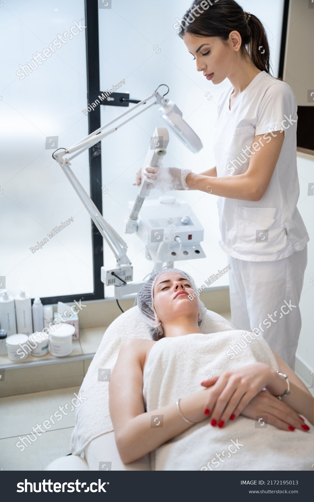 Beautiful woman on ozone therapy with facial steamer in beauty salon. #2172195013