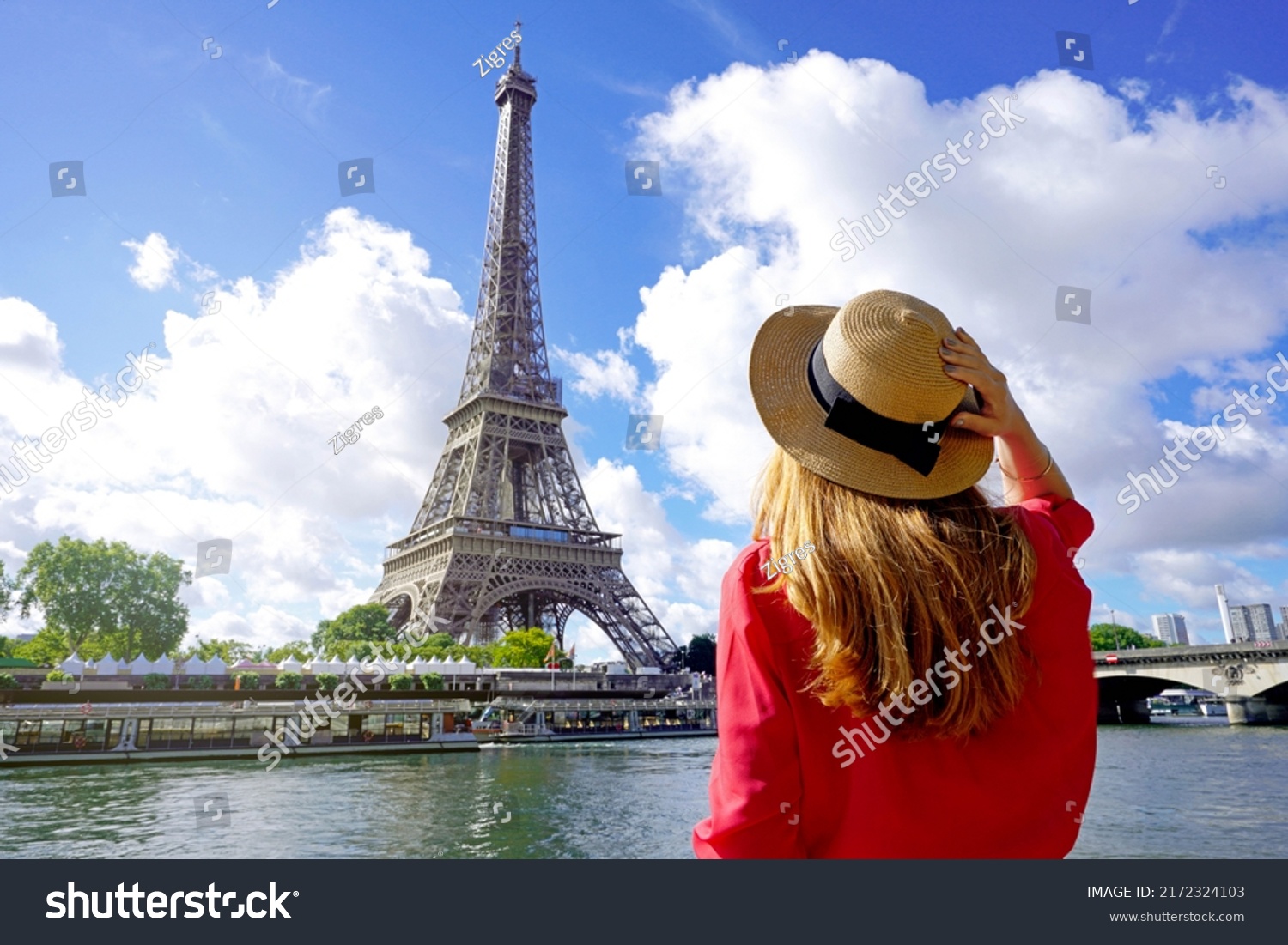 Holidays in Paris. Back view of beautiful fashion girl enjoying view of Eiffel Tower in Paris, France. Summer vacation in Europe. #2172324103