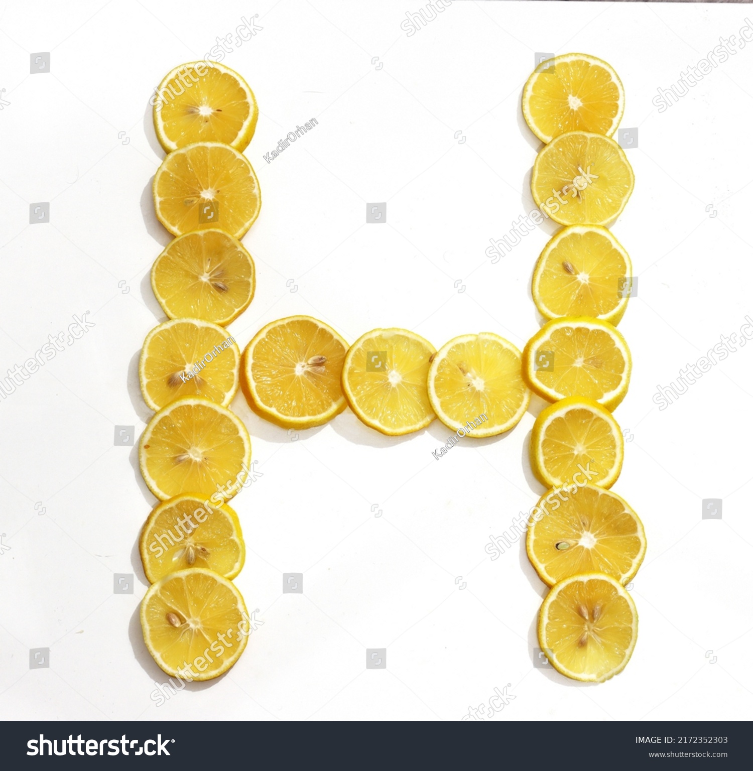 Letter H made with citrus fruits on white background as vitamin representation, top view.Letter C made with citrus fruits  on white background as vitamin representation, top view. Lemon letter. #2172352303