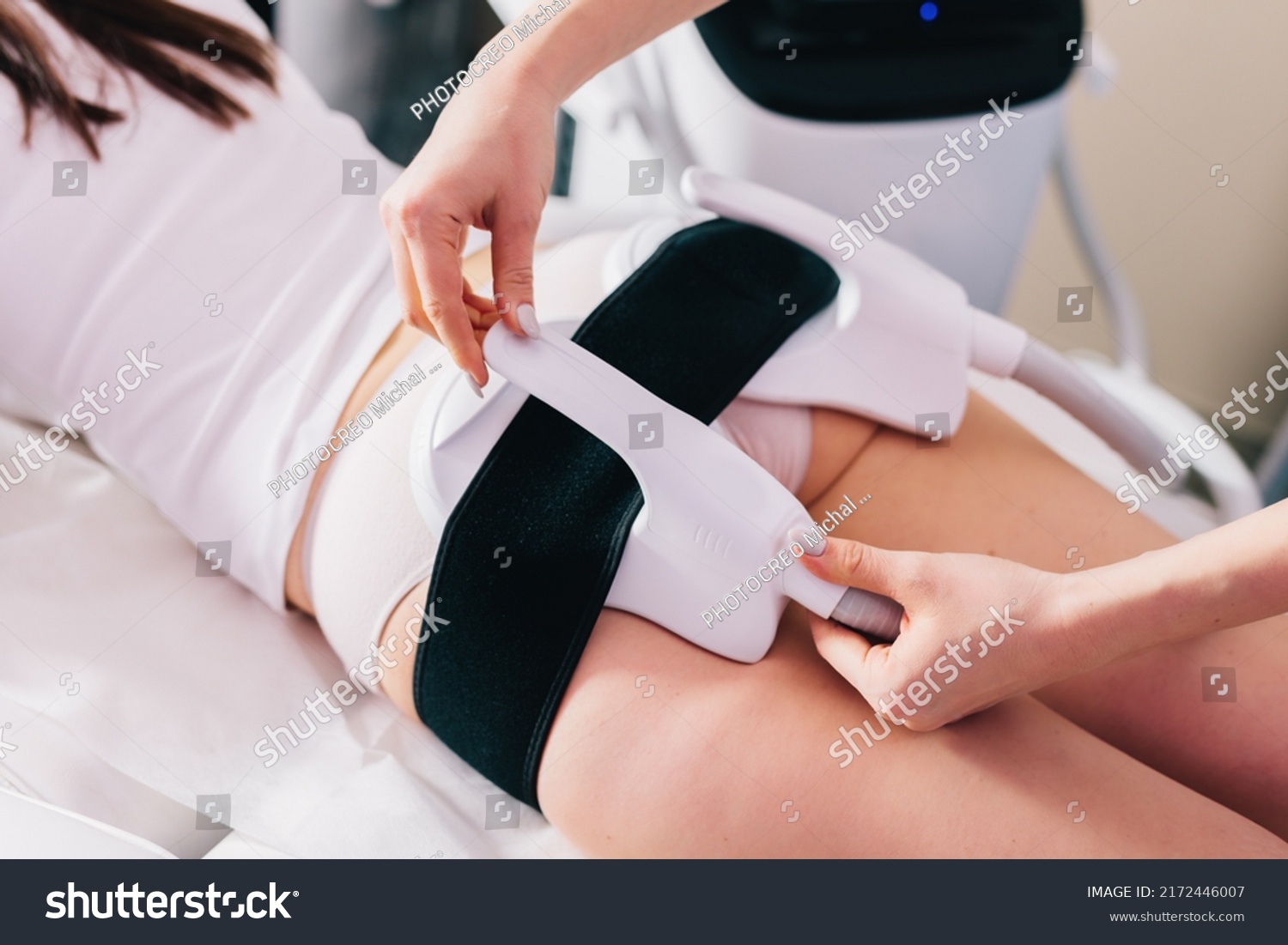 Woman getting treatment on buttocks to burn fat, build muscles and remove cellulite. Professional beauty salon #2172446007