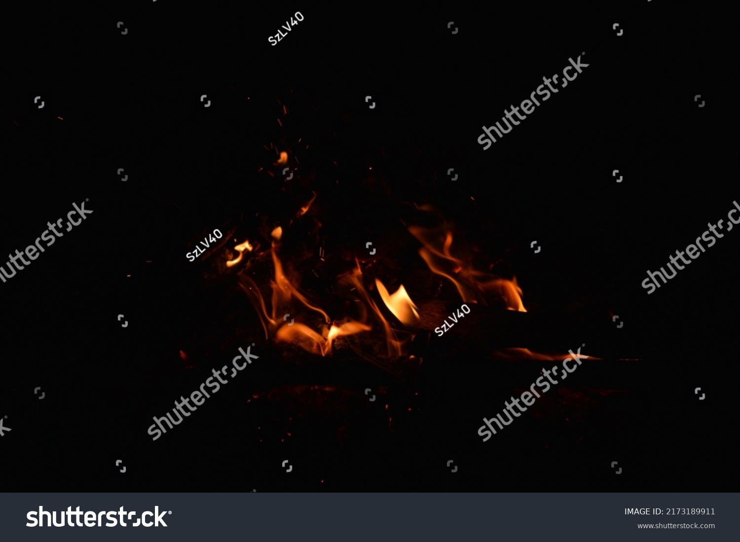 Small flames from a bonfire at night #2173189911