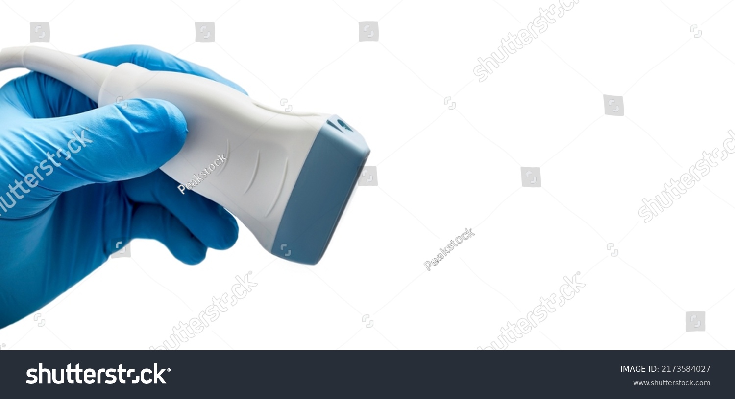 Medical ultrasound probe from ultrasonic machine in doctor's hand close-up, isolated on white. Ultrasound procedures #2173584027