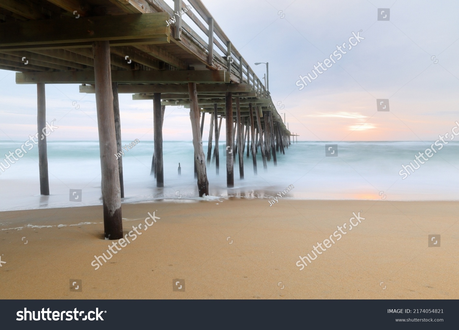 Beautiful sunrise at Nags Head Pier, Outer Banks, North Carolina, USA.  Nags Head is one of the most popular beach of the outer Banks for its  wealth of amenities, sprawling ocean and soundfront view #2174054821