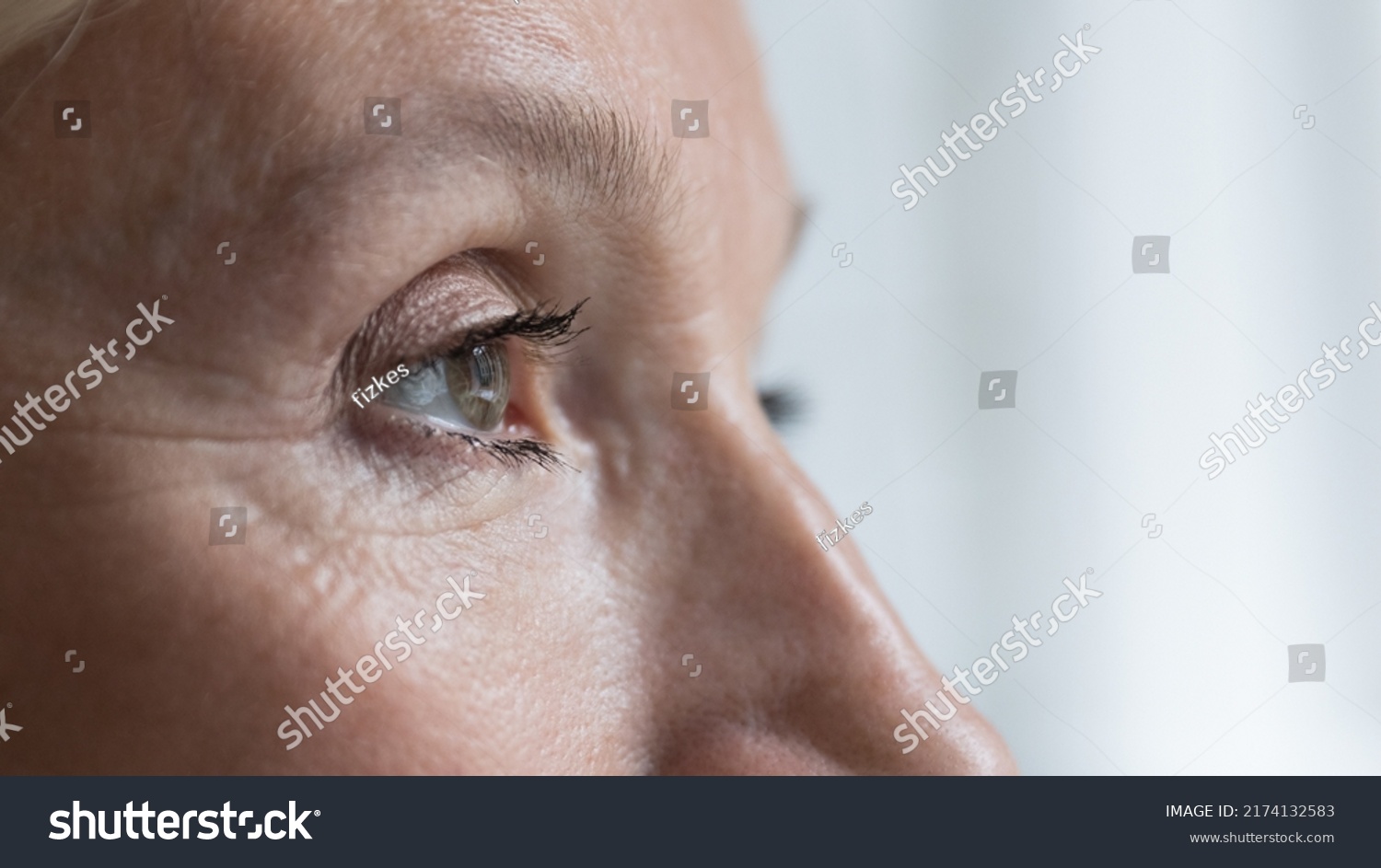 Close up cropped shot, face of senior woman eye looking straight, into distance. Eyesight, ophthalmology clinic advertisement for older, eye-care, disease prevention, vision care and treatment concept #2174132583