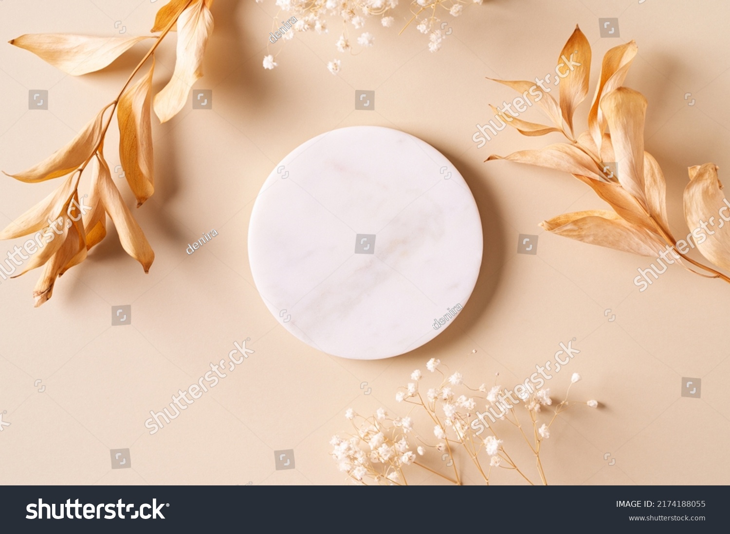 Dry natural grass, leaves and flowers frame with white marble podium, beauty and fashion concept mock up on beige background flat lay, top view, copy space #2174188055
