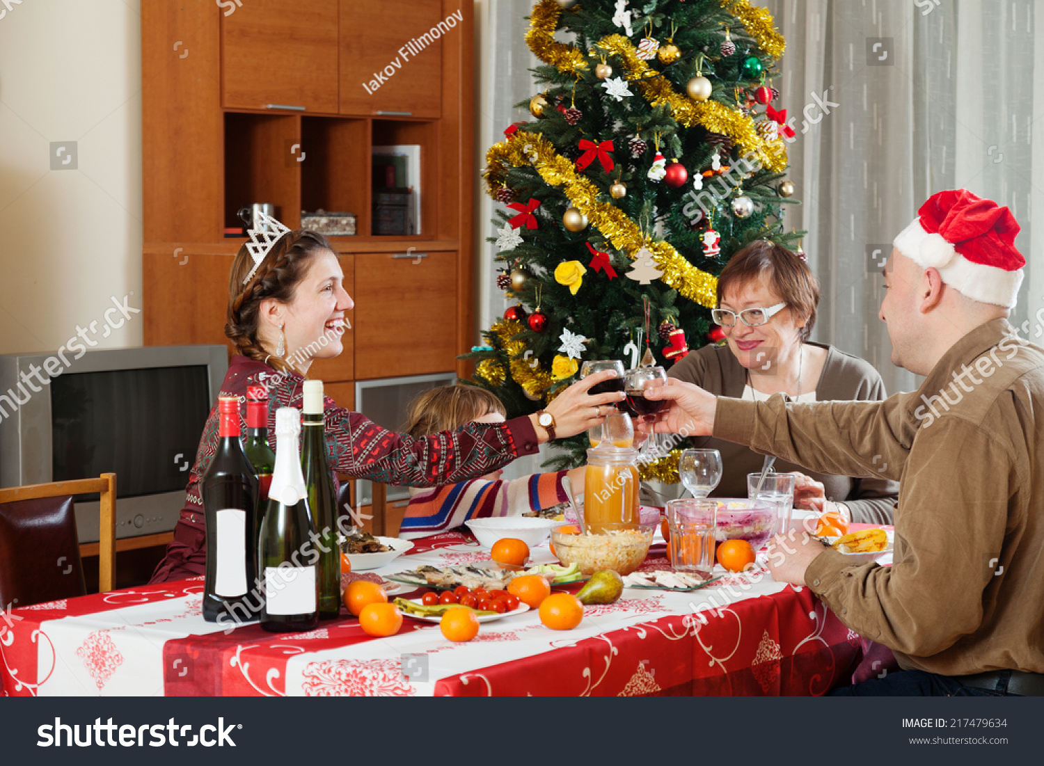 Happy family of three generations celebrating New Year over celebratory table at home   #217479634