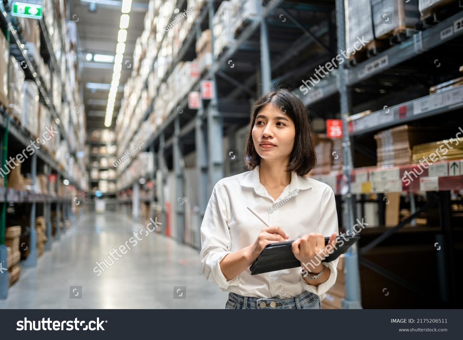 Woman worker using digital tablet checking the stock inventory, Smart warehouse management system, Supply chain and logistic network technology concept. #2175206511