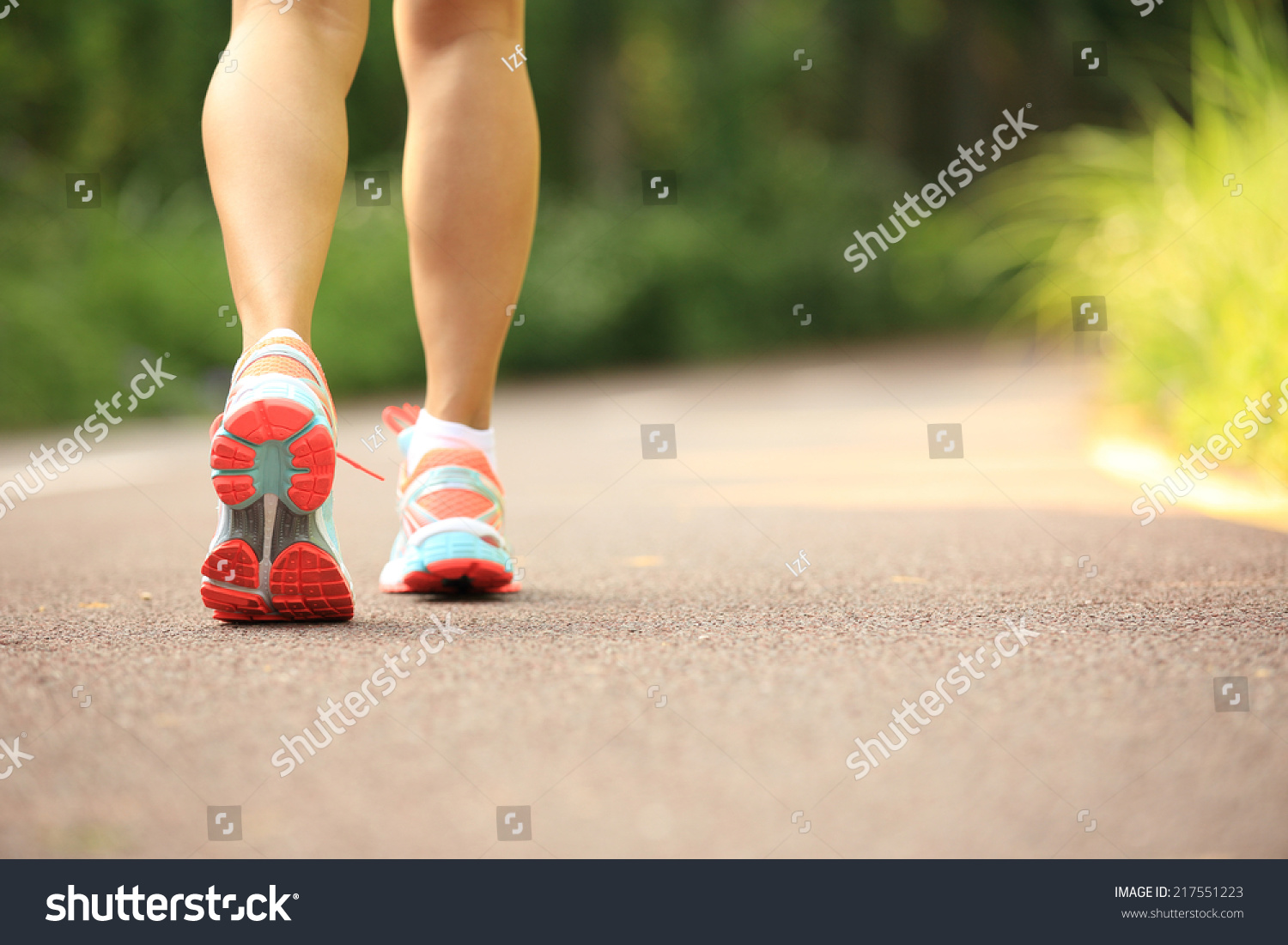 young fitness woman legs running at forest trail  #217551223