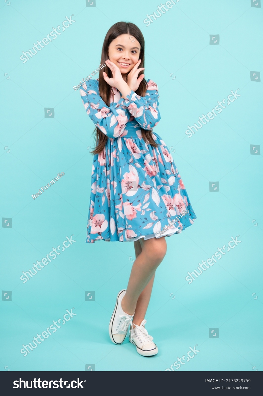 Full length of teenager child wearing summer dress. Happy teenager, positive and smiling emotions. Elegant teenager child girl in fashion dress. Girl in cotton dress isolated on blue background. #2176229759