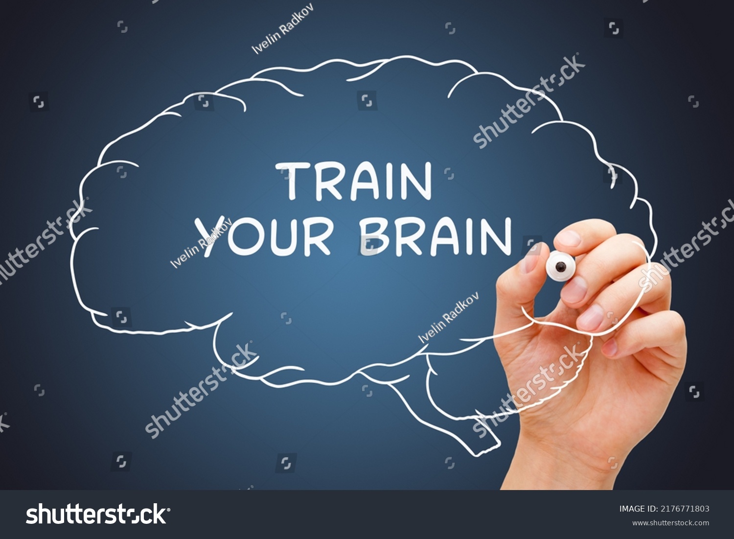Hand writing Train Your Brain on drawn human brain with white marker on transparent glass board. #2176771803