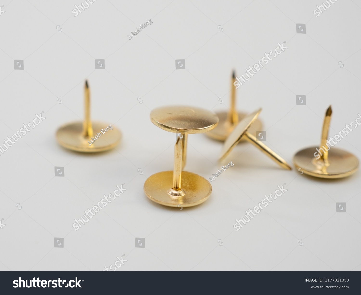 Set of golden thumbtacks. Golden buttons. #2177021353