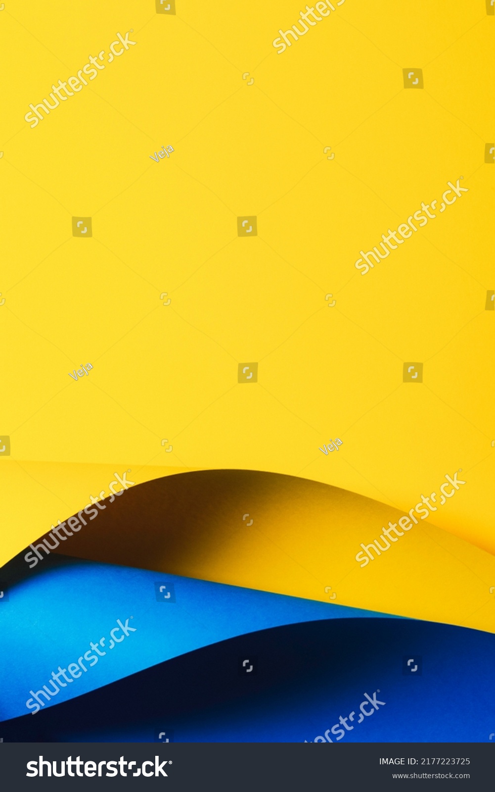 Abstract wave of yellow and light blue paper. Creative geometric curved paper with light and shadows. Abstract geometry background with copy space #2177223725