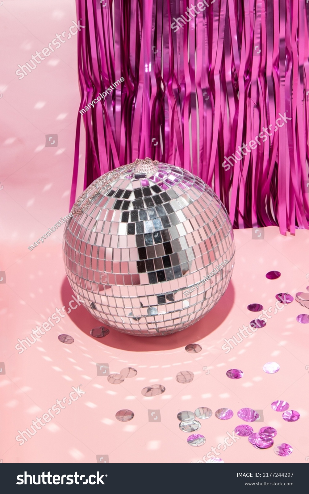 Shiny disco ball, courtain and confetti on pastel light pink background. Trendy party symbols concept. Minimalistic celebration composition. #2177244297