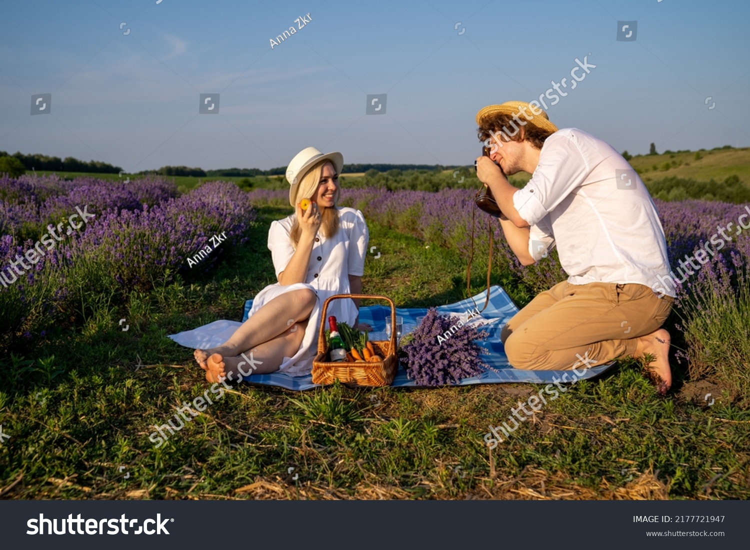 couple in purple lilac outfit have picnic in lavender field, photo session. Romance #2177721947