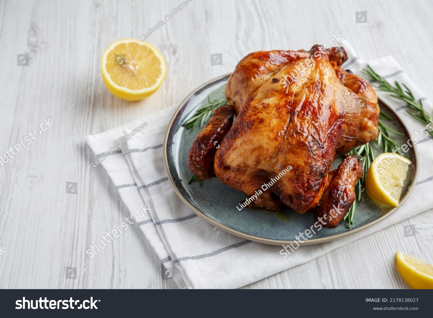 Homemade Lemon and Herb Rotisserie Chicken on a Plate, low angle view. Copy space. #2178138027