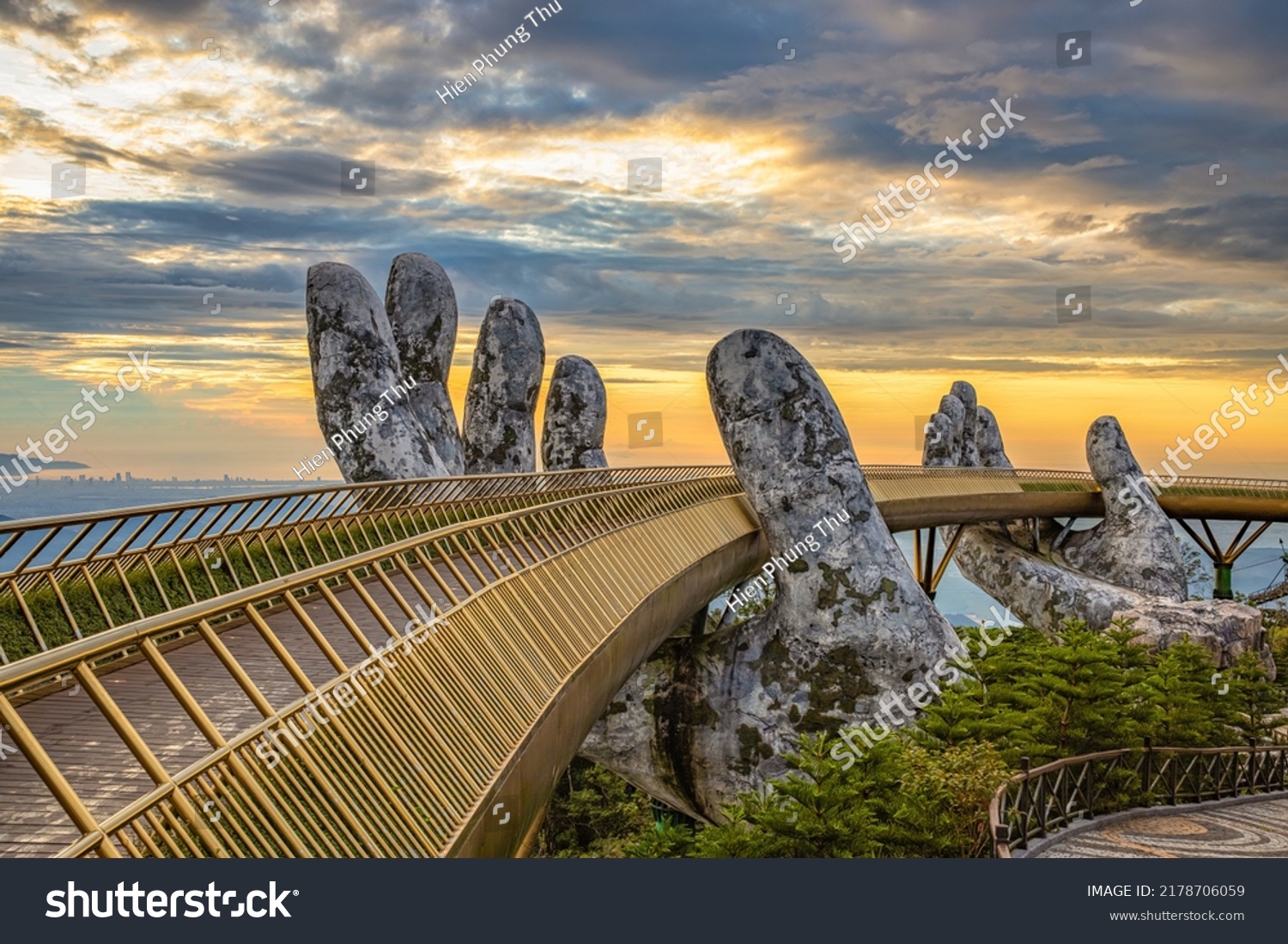 Aerial view of the Golden Bridge is lifted by two giant hands in the tourist resort on Ba Na Hill in Da Nang, Vietnam. Ba Na mountain resort is a favorite destination for tourists #2178706059