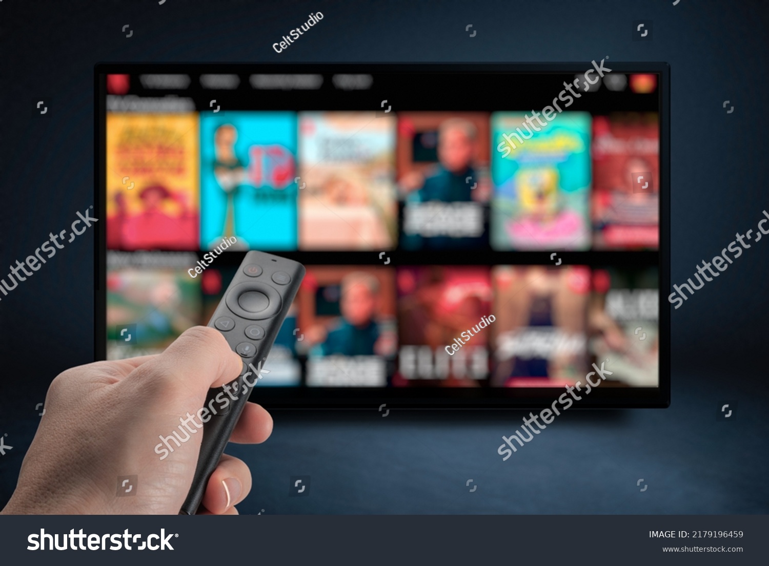 Tv online. Television streaming video. Media TV on demand. Online Multimedia video concept on TV set in dark room. Watching online TV with remote control in hand. #2179196459