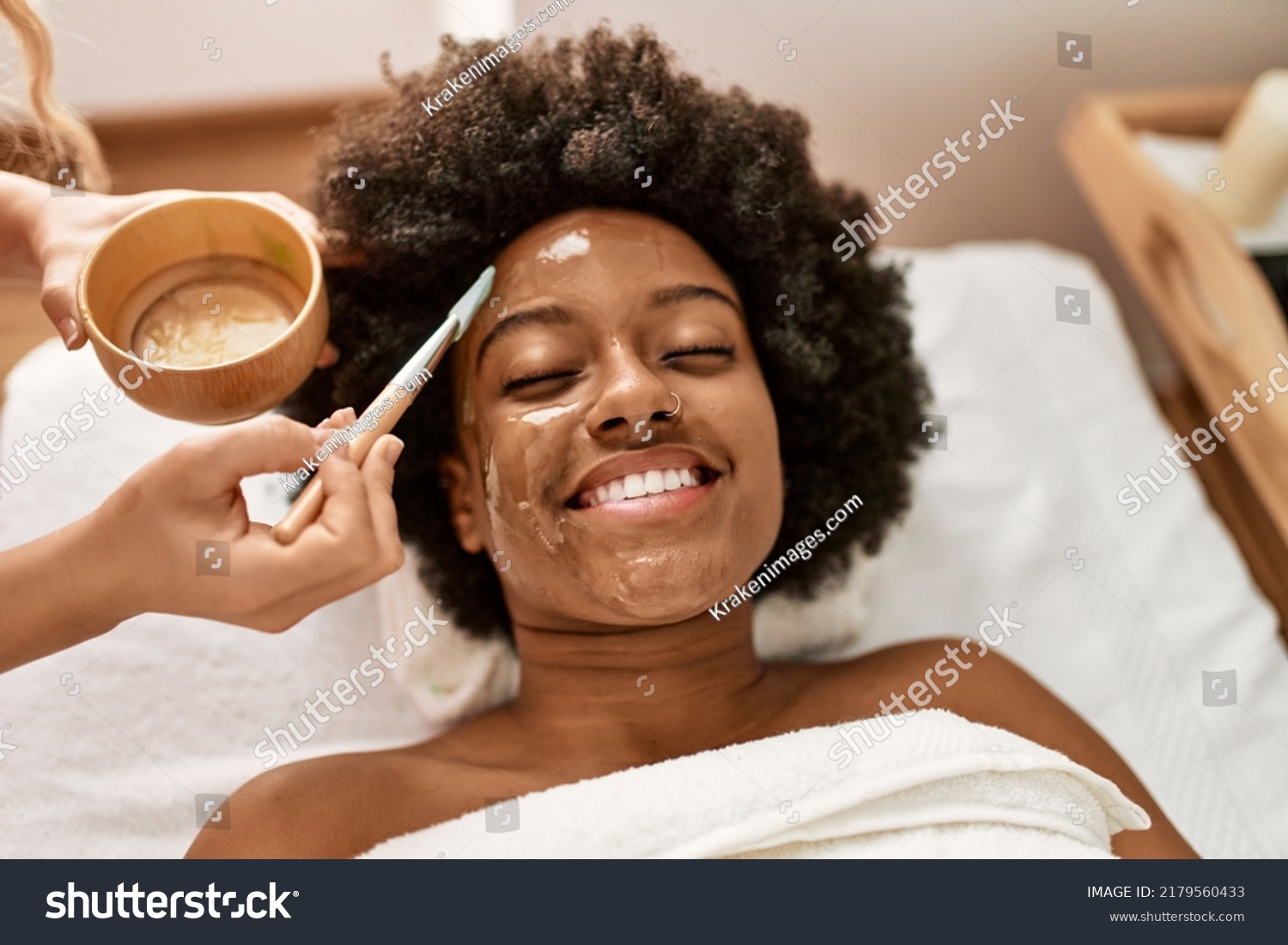 Young african american woman smiling confident having facial treatment at beauty center #2179560433