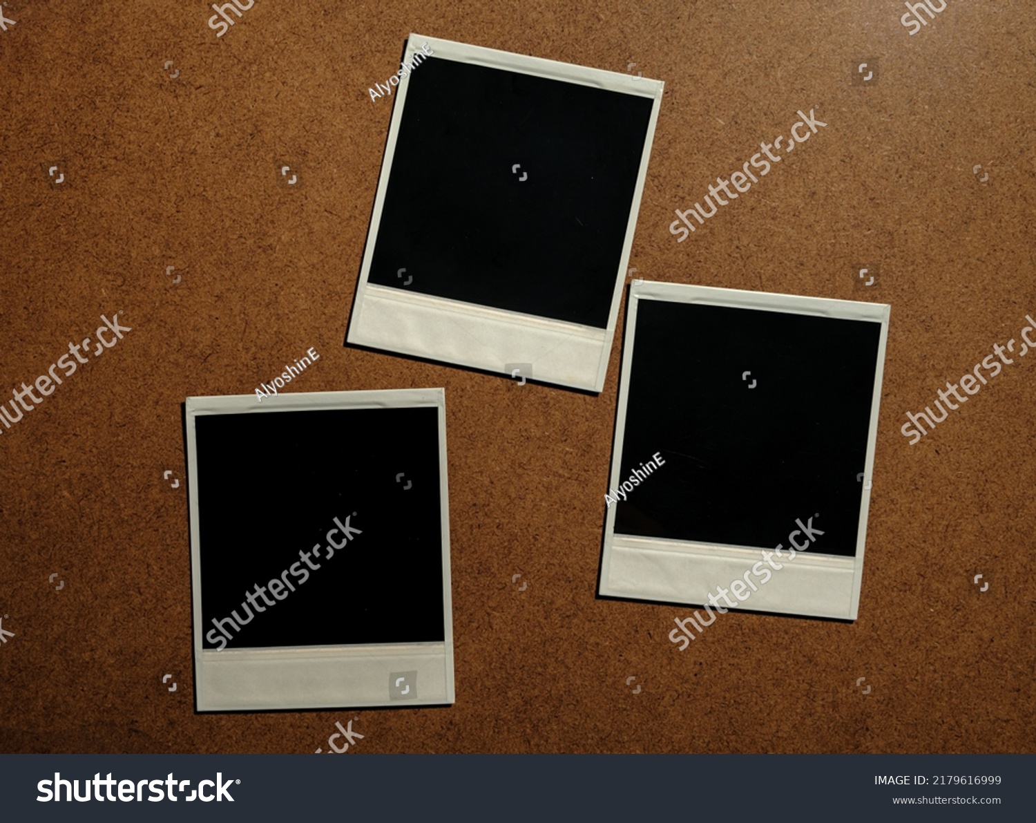 Three blank photo frames on brown table #2179616999