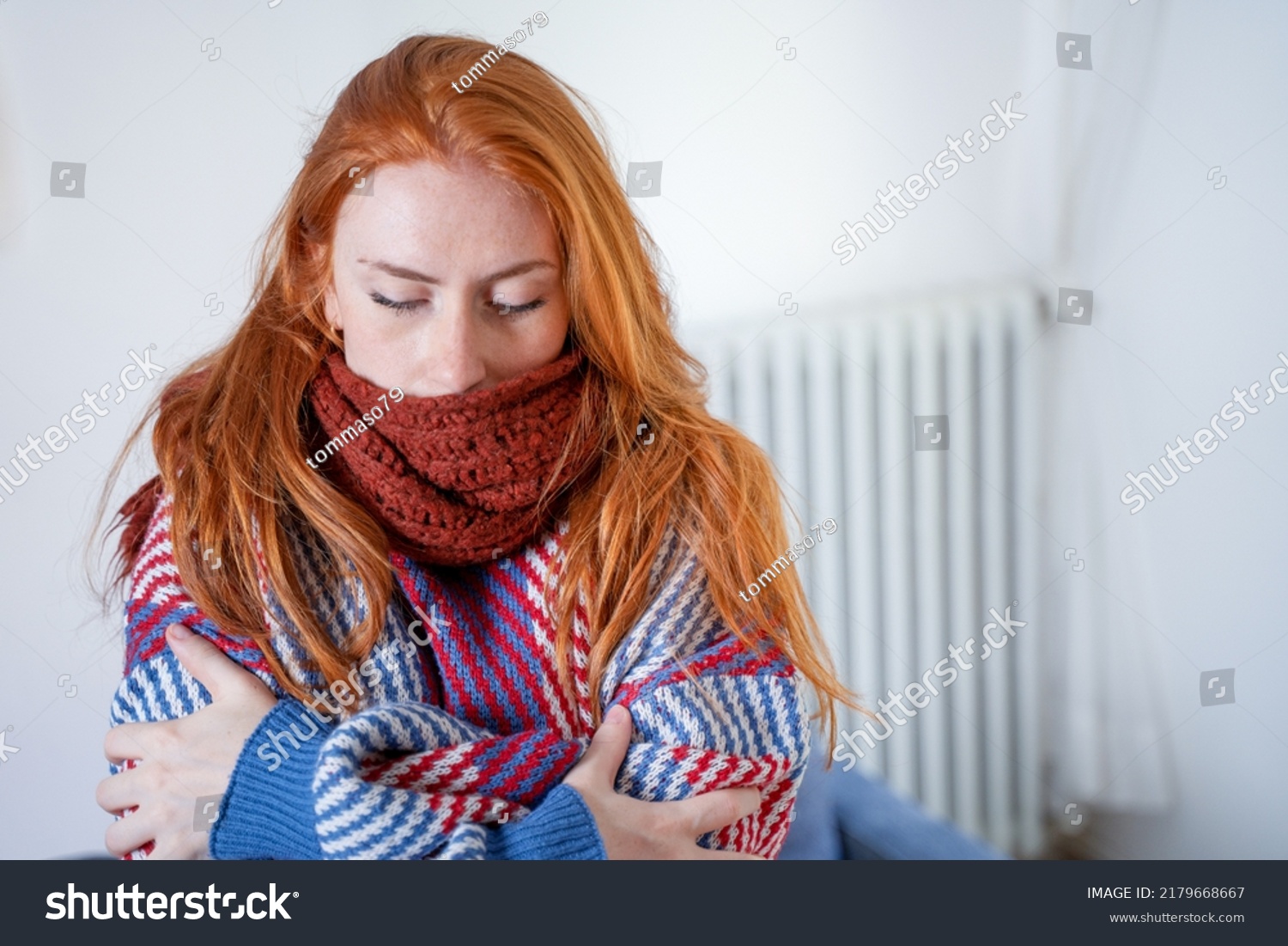 One person feeling cold at home having heating problem #2179668667