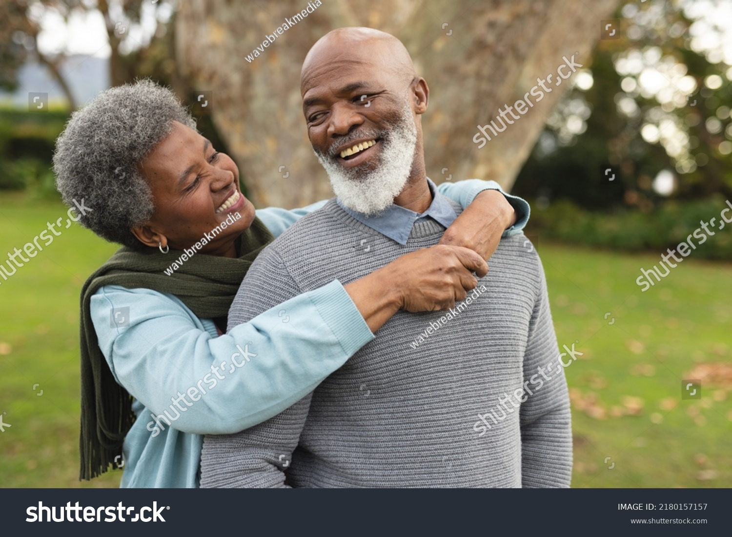 Image of happy african american senior couple posing at camera outdoors in autumn. Family, spending quality time together concept. #2180157157