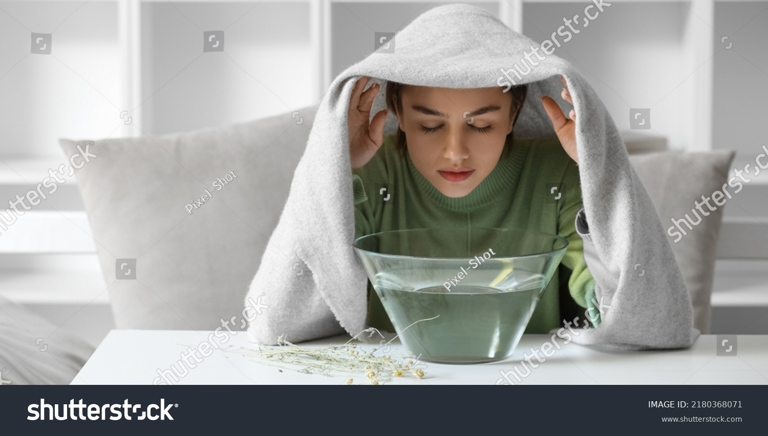 Young woman doing steam inhalation at home to soothe and open nasal passages #2180368071