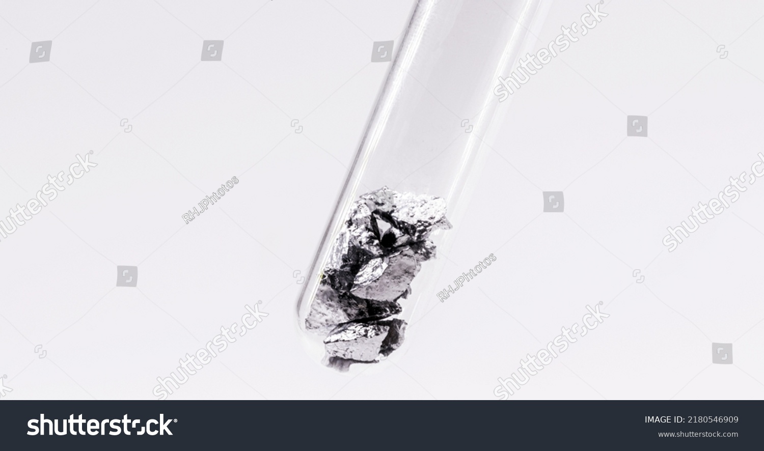 Chromium fragments inside test tube, industrial use ore, metallic chemical element, isolated on white background #2180546909