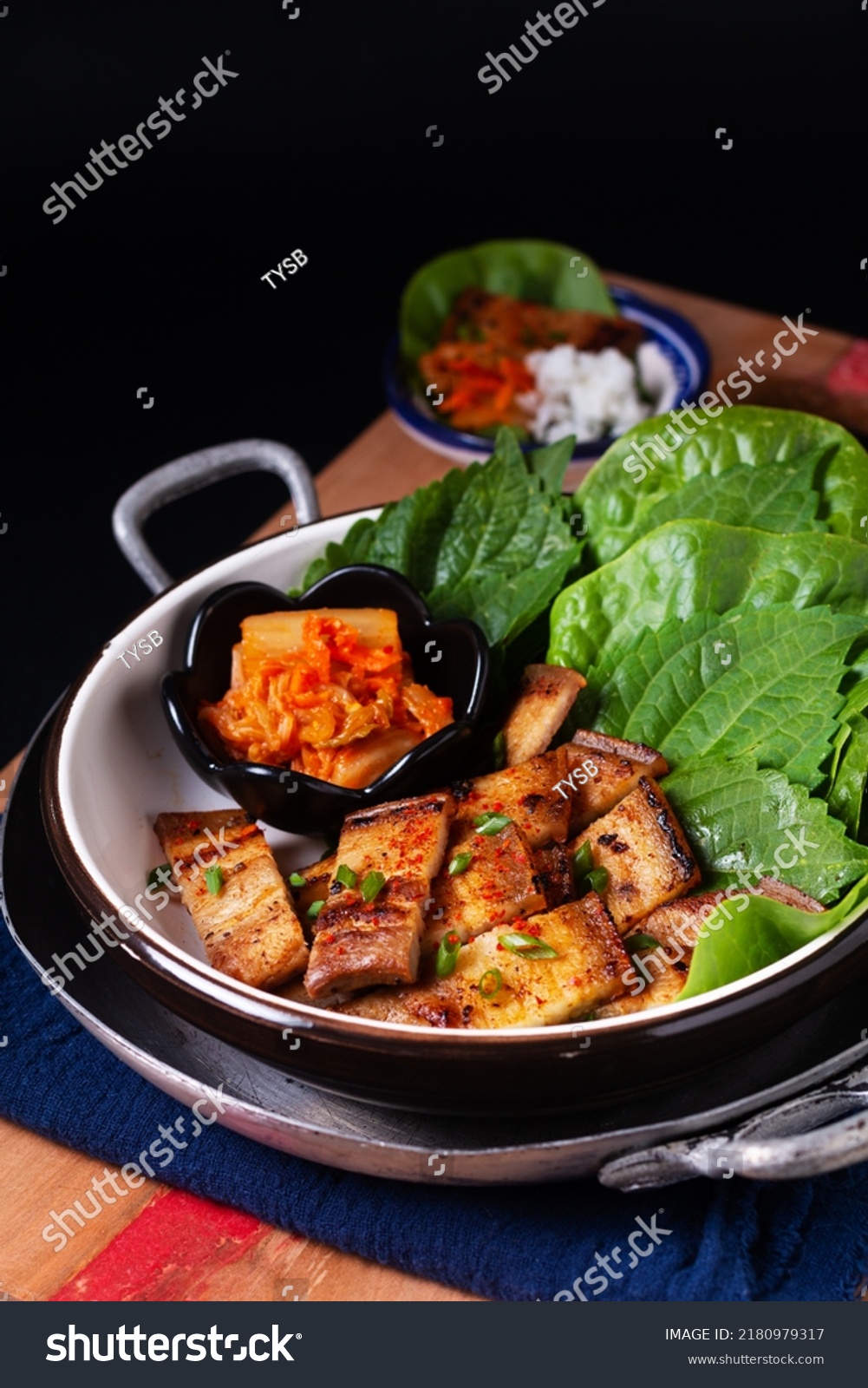 Asian food concept homemade Korean Grilled pork belly BBQ Samgyeopsal-gui with kimchi and shiso and salad on black background with copy space #2180979317