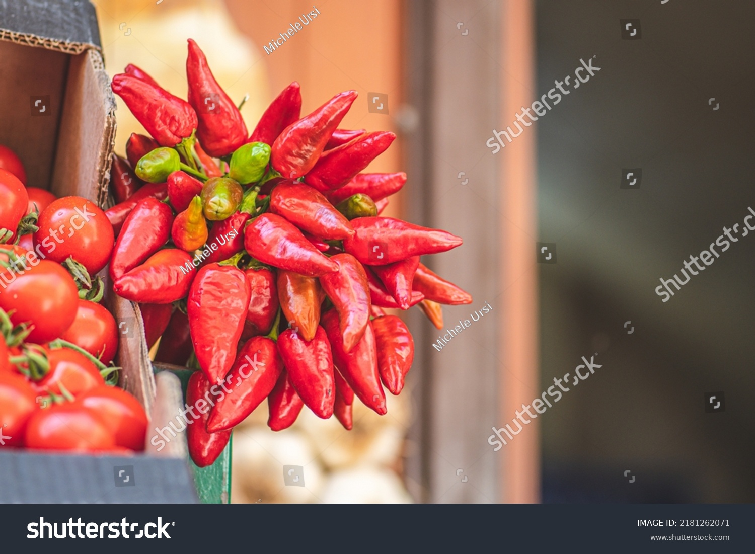 Bunch of red hot chili peppers hanging in a street food market, close up #2181262071