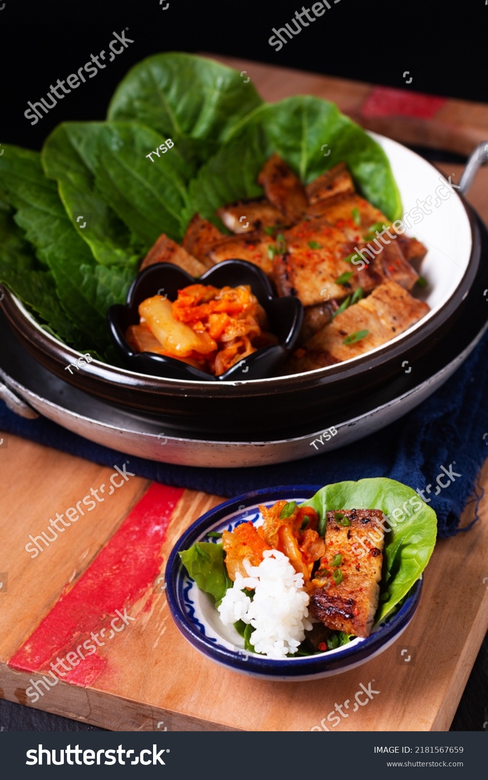 Asian food concept homemade Korean Grilled pork belly BBQ Samgyeopsal-gui with kimchi and shiso and salad on black background with copy space #2181567659