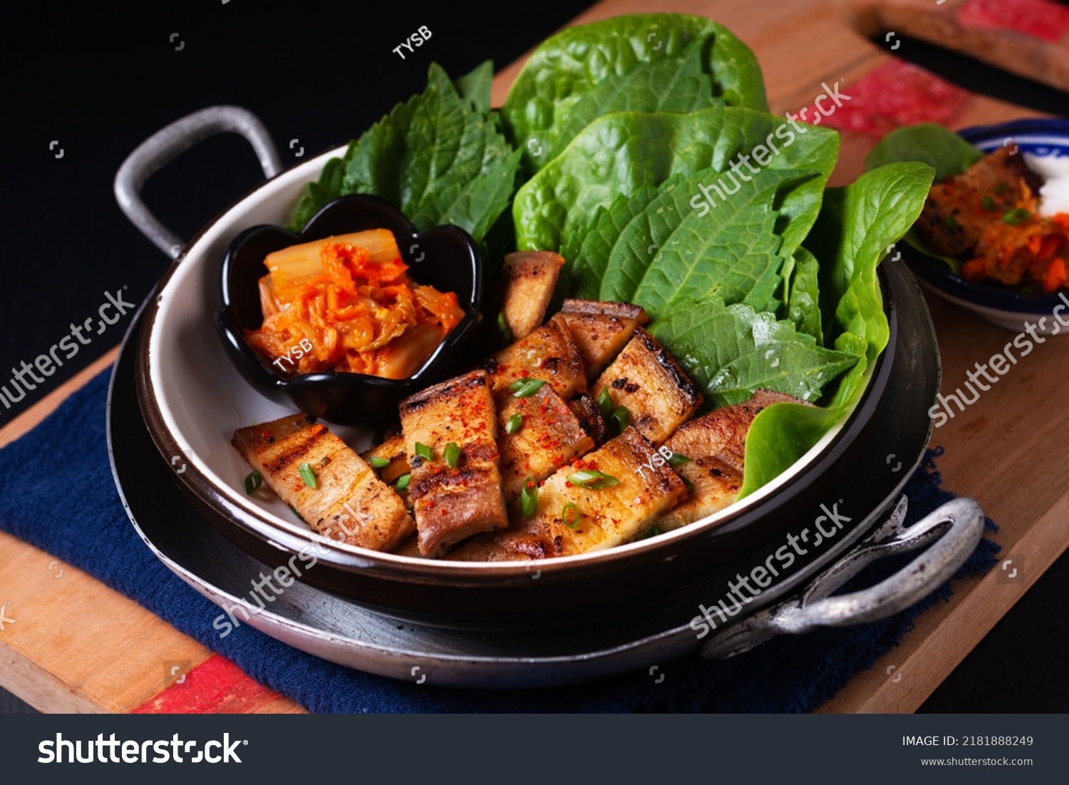 Asian food concept homemade Korean Grilled pork belly BBQ Samgyeopsal-gui with kimchi and shiso and salad on black background with copy space #2181888249