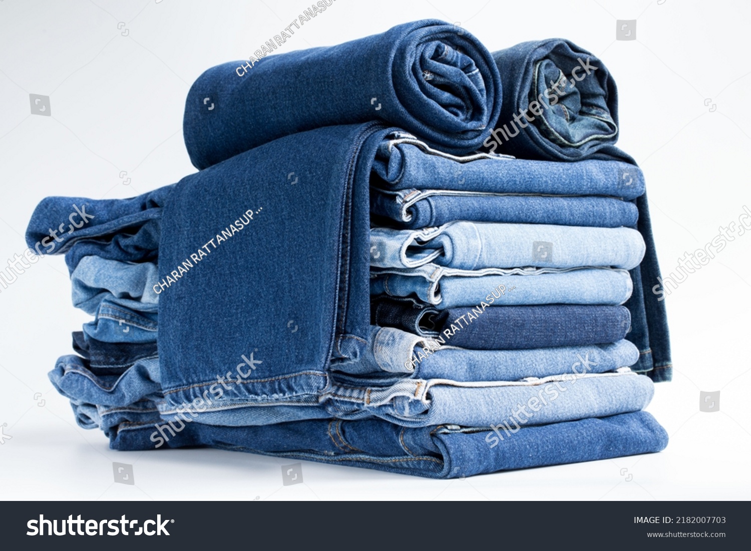 Jeans trousers stack on white background in supermarket and store. business jeans concept. #2182007703