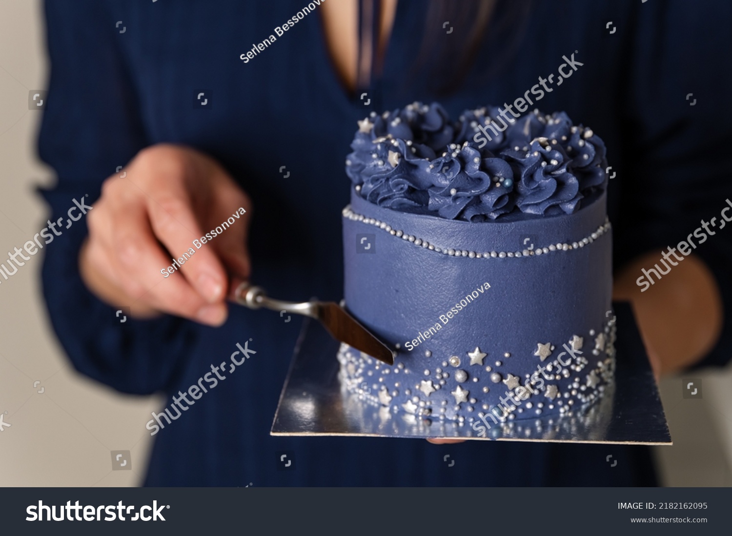 Birthday cake held by a baker in a bakery. Portrait of caucasian woman sharing fresh cake. Chef holding plate with sweet dessert. Unrecognizable female cook showing refreshing dessert. #2182162095
