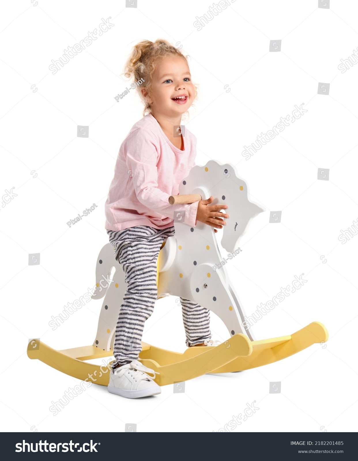 Adorable little girl with rocking horse on white background #2182201485