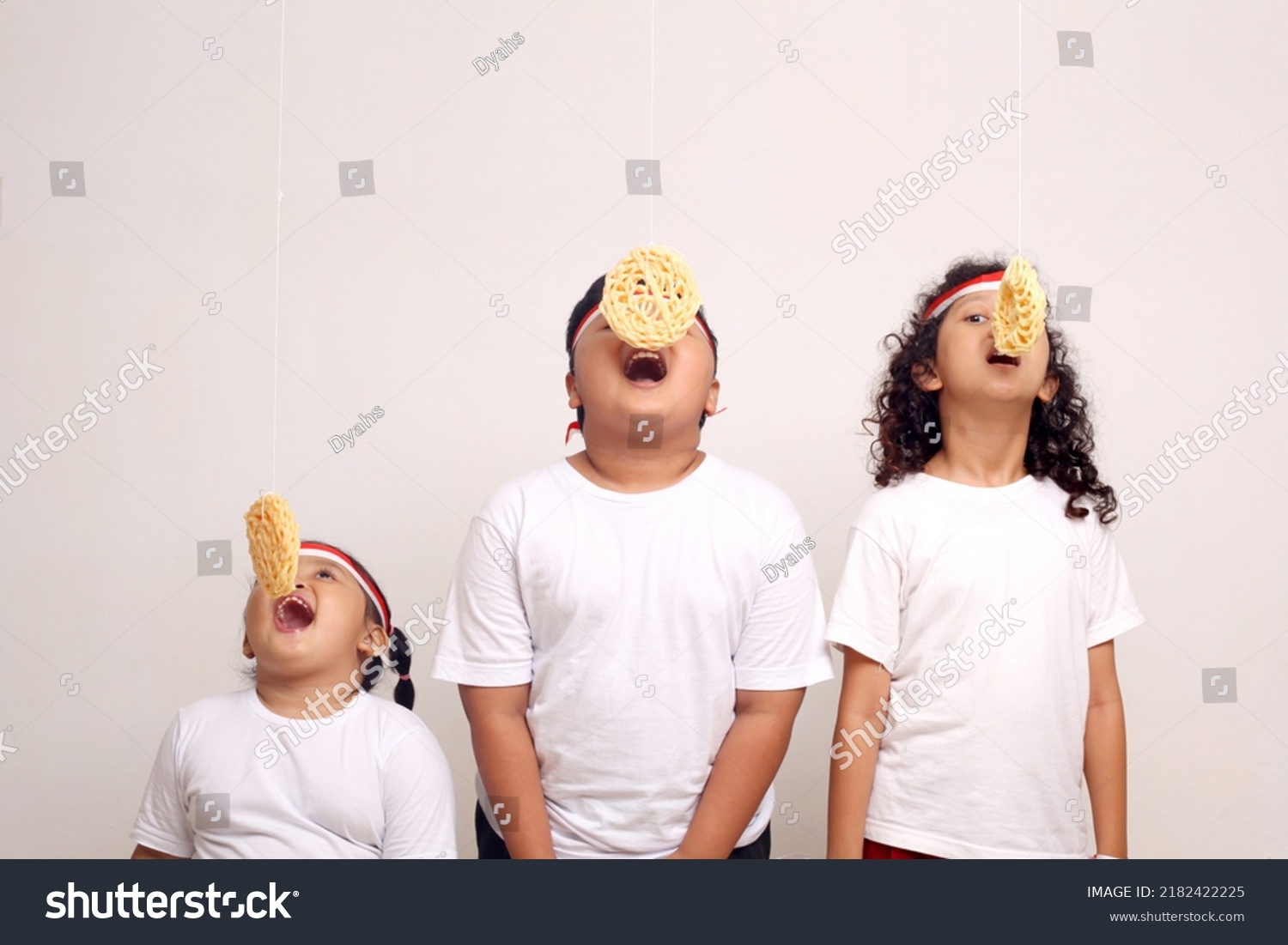 Asian kids celebrating indonesian independence day with cracker eating contest. #2182422225