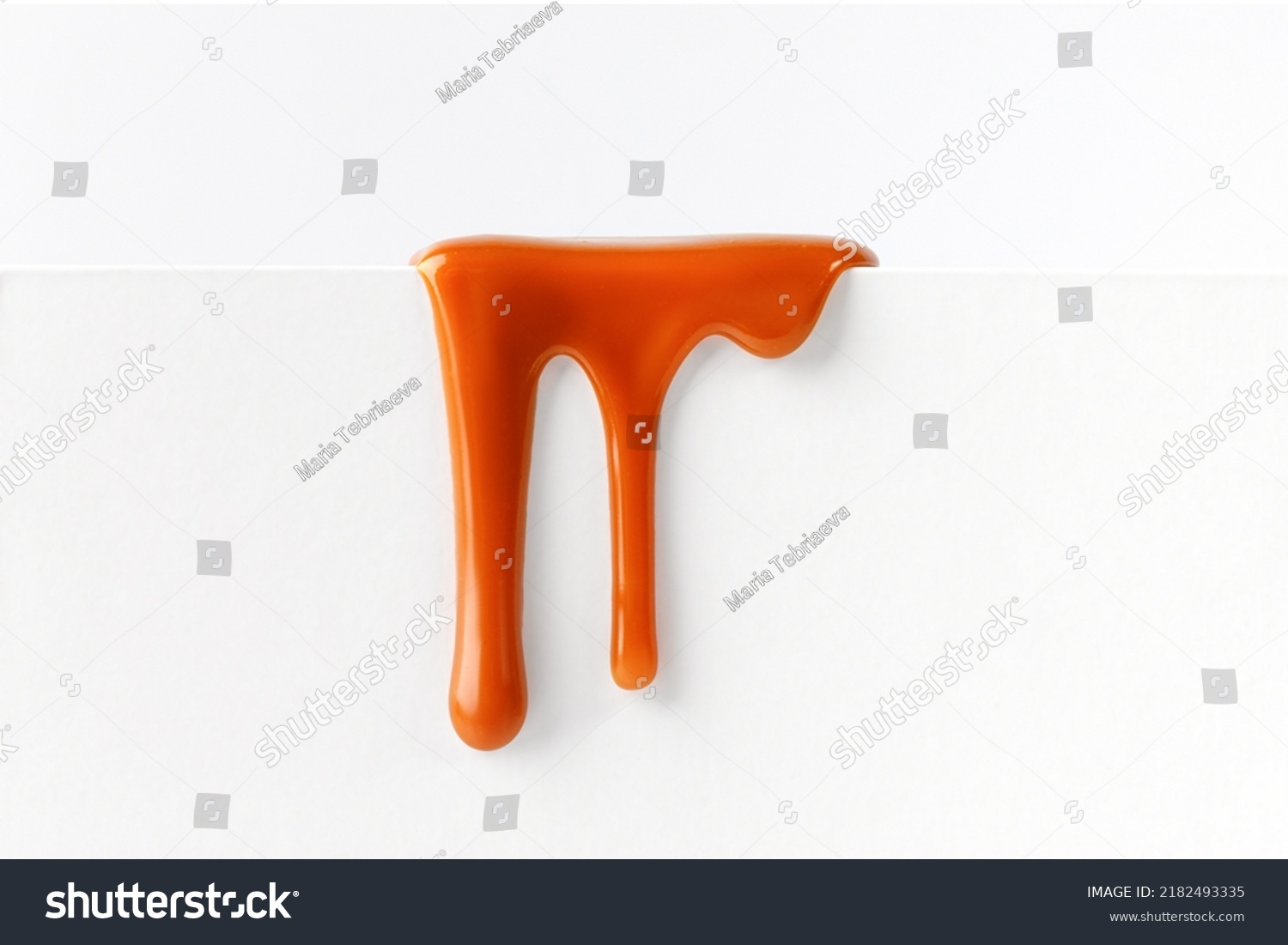 Dripping caramel drops of sweet caramel sauce isolated on white background. Melted caramel sauce drip, drops of sweet liquid toffee. #2182493335